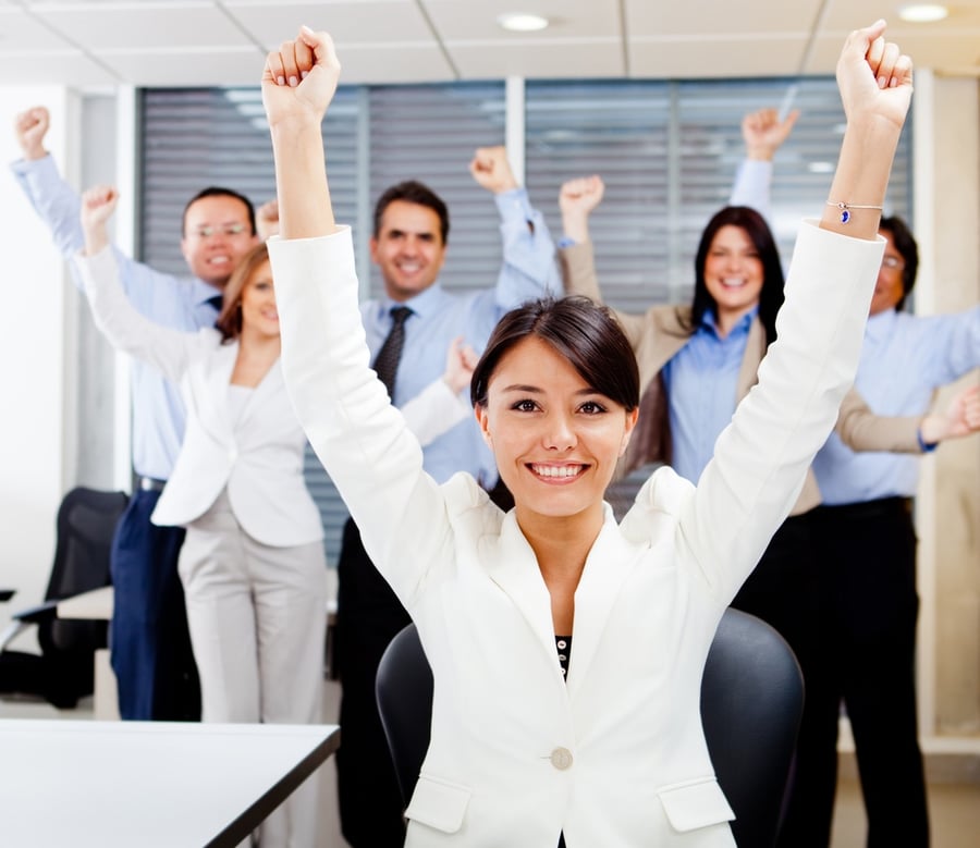 Business woman leading a successful group with arms up