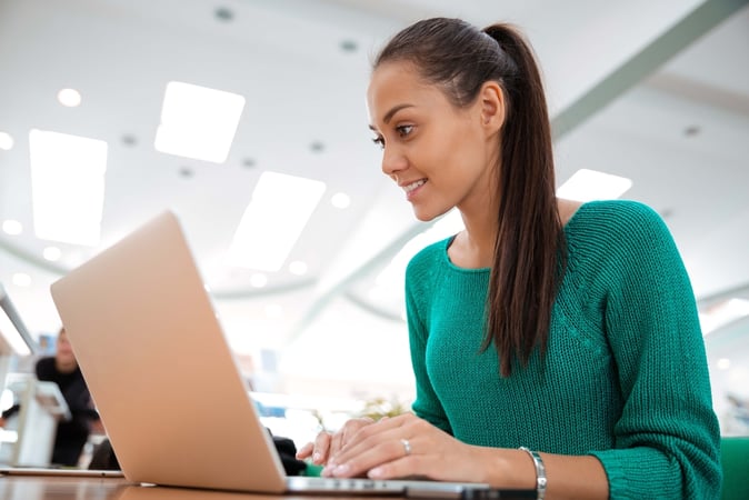 lady sitting at a desk using her laptop