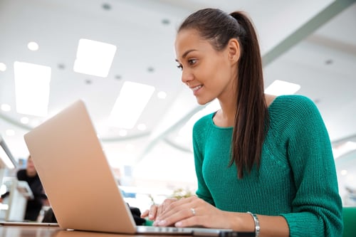 lady sitting at a desk using her laptop