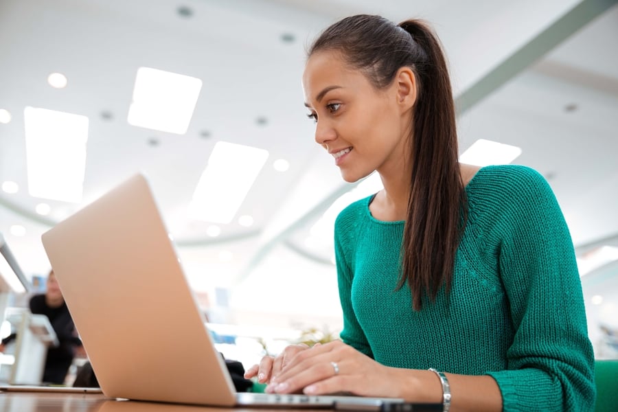 lady sitting at a desk using her laptop