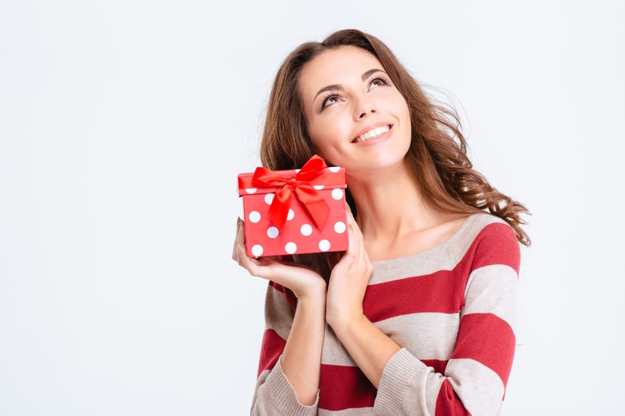 lady wearing a red and white striped sweater holding a gift