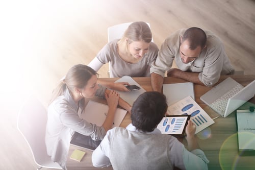 Upper view of business people around table