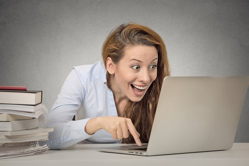 smiling lady with laptop - typing with index finger