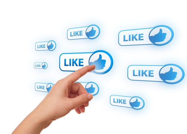 Finger pressing the "like" button on a screen.