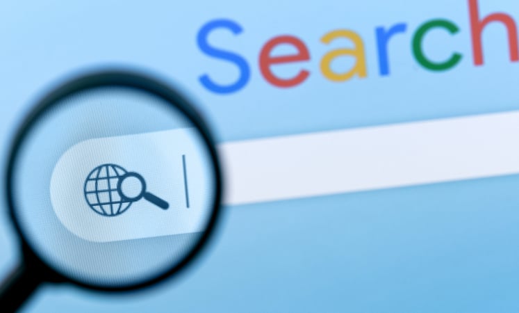 Internet search bar in browser with magnifier on computer screen