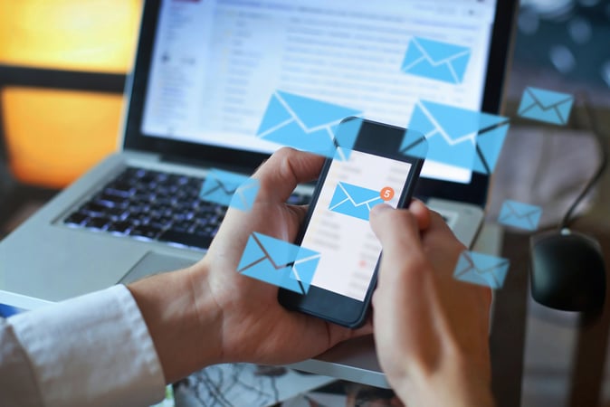 Email marketing concept of person reading email on phone 