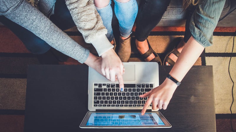 1. pie graph 2. blue background with icons and the words "attention, interest, desire, action" 3. colored boxes with the words "awareness, consideration, purchase, retention, advocacy"4. picture of the Attribution report screen in HubSpot 5. laptop with people huddled around pointing at screen