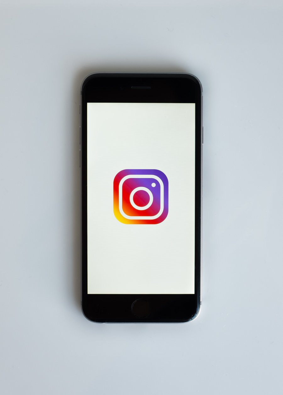 adWhite marketing's need to know about Instagram phone showing Instagram logo